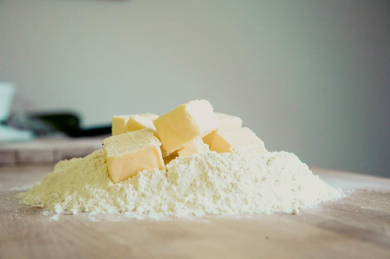 Butter on top of pile of flour